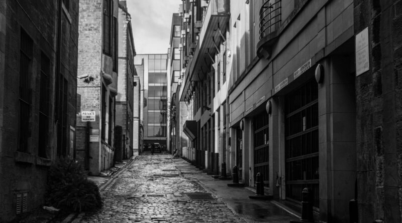Old narrow cobblestone street, evoking early 20th century Boston before the Great Molasses Flood