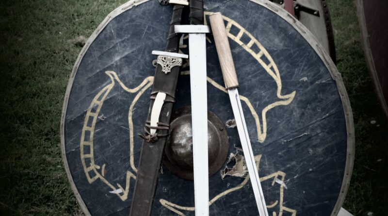 Metal Viking helmet with sword and shield showing no horns
