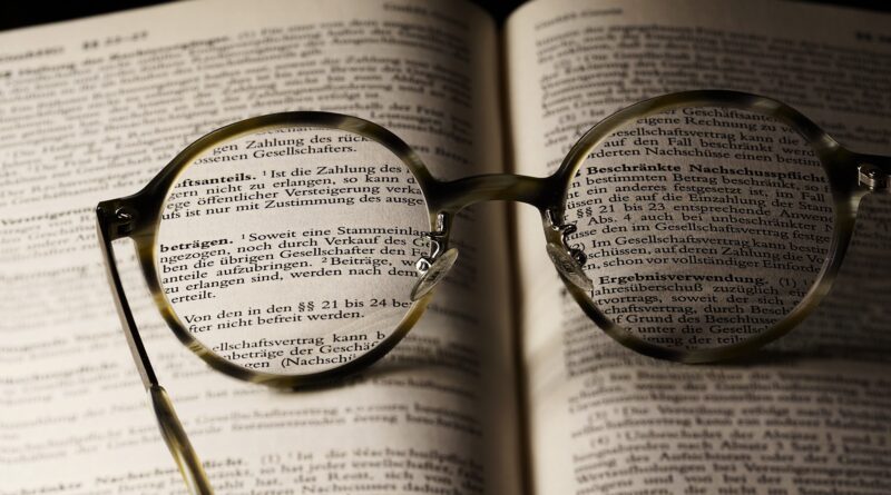 Reading glasses on open book page